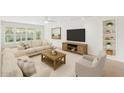 Bright living room features neutral decor, a ceiling fan, and large windows overlooking the landscaped yard at 315 E Marlette Ave, Phoenix, AZ 85012