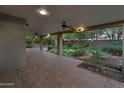 Spacious covered patio features brick flooring, ceiling fans, and views of the landscaped backyard at 315 E Marlette Ave, Phoenix, AZ 85012