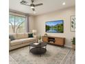 Bright living room featuring a neutral color scheme, large windows, and contemporary furnishings at 34710 N 27Th Ave, Phoenix, AZ 85086