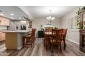Dining area with plank flooring, modern light fixture, and breakfast bar at 3526 N 85Th St, Scottsdale, AZ 85251