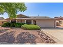 Traditional home showcasing desert landscaping, concrete driveway, and attached two-car garage at 3526 N 85Th St, Scottsdale, AZ 85251