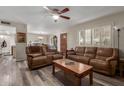 Open-concept living room showcasing plank flooring, wood door, and plantation shutters at 3526 N 85Th St, Scottsdale, AZ 85251