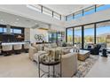Bright, open living space with high ceilings, floor-to-ceiling windows, and views to outdoor spaces at 37200 N Cave Creek Rd # 1013, Scottsdale, AZ 85262