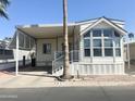 Inviting single-story home featuring covered parking and large windows for ample natural light at 381 S Gypsum Dr, Apache Junction, AZ 85119