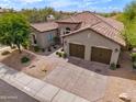 Charming home with a tile roof, a two-car garage, and lovely desert landscaping at 3841 E Patrick Ln, Phoenix, AZ 85050