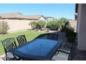 Private backyard featuring outdoor dining area, artificial turf, and a fire pit at 3850 E Balsam Dr, Chandler, AZ 85286