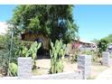 Landscaped front yard featuring native plants and a low stone wall at 4116 N 78Th Ave, Phoenix, AZ 85033