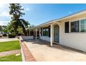 Cozy covered porch with stylish door and black window shutters at 4314 E Montecito Ave, Phoenix, AZ 85018