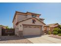 Charming two-story home with a spacious driveway and desert landscaping at 4347 W Darrel Rd, Laveen, AZ 85339