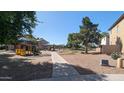 Community playground area with a play structure and covered ramada with picnic tables at 5311 W Fulton St, Phoenix, AZ 85043