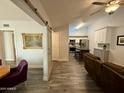 Open-concept living area with wood flooring, modern lighting, and slider to dining room at 555 N May -- # 1, Mesa, AZ 85201
