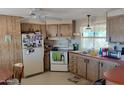 Functional kitchen with ample cabinet space, white appliances, and a cozy breakfast nook at 649 S 87Th Way, Mesa, AZ 85208