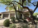Charming two-story home featuring a two-car garage and desert landscaping at 7336 E Overlook Dr, Scottsdale, AZ 85255