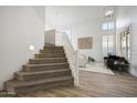 Bright foyer with high ceilings, staircase, and wood-look tile flooring at 7336 E Overlook Dr, Scottsdale, AZ 85255