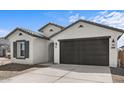 Beautiful single-story home features a two-car garage and neutral stucco at 7643 W Park St, Laveen, AZ 85339