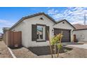 A single-story home featuring a two-car garage and neutral stucco at 7643 W Park St, Laveen, AZ 85339