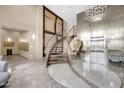 Elegant lobby showcasing a striking staircase, tiled floors, and elevator access at 945 E Playa Del Norte Dr # 1003, Tempe, AZ 85288