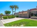 Beautiful single-story home showcasing mature trees, a well-kept lawn, and a convenient three-car garage with tile roofing at 9847 E Michigan Ave, Sun Lakes, AZ 85248
