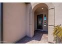 Inviting entryway featuring a decorative front door and brick-paved flooring at 132 E El Prado Dr, Queen Creek, AZ 85140