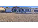 Charming single-story home with a rock front yard and adorned with decorative floral accents at 1529 W Wickieup Ln, Phoenix, AZ 85027