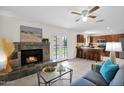 Open-concept living room featuring a fireplace, tile flooring, and seamless connection to the kitchen at 16421 N 65Th Pl, Scottsdale, AZ 85254
