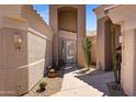 Close up of entrance, featuring desert landscaping, pavers, desert plants and an iron security screen door at 16450 E Ave Of The Fountains -- # 14, Fountain Hills, AZ 85268