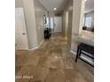 Inviting entryway with tile floors, neutral walls, leading to the front door and living areas at 17447 W Yavapai St, Goodyear, AZ 85338