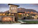 Elegant community entrance featuring stone architecture and mountain views at 17673 E Bronco Dr, Queen Creek, AZ 85142