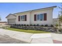 Attractive single-story house with white siding, red shutters, and well-maintained front yard landscaping at 2153 E Cherrywood Pl, Chandler, AZ 85249
