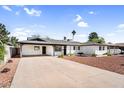 Inviting single-story house with a clean concrete driveway and desert-style landscaping at 2232 E Karen Dr, Phoenix, AZ 85022