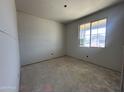 Unfinished bedroom with a large window providing natural light, awaiting personalization at 22812 E Lords Way, Queen Creek, AZ 85142