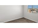 Empty bedroom with neutral walls, carpeted floor, and a window offering natural light at 2530 N Pony Ln, Casa Grande, AZ 85122