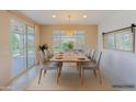 Elegant dining room with a modern light fixture and sliding glass doors to the patio at 26733 W Melinda Ln, Buckeye, AZ 85396