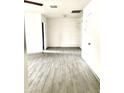 Bright and airy living room with wood-look tiled flooring and a closet space at 2925 N 19Th Ave # 97, Phoenix, AZ 85015