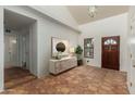 Bright entryway with striking tile floors, clerestory windows, and stylish console with artwork at 3030 W Christy Dr, Phoenix, AZ 85029