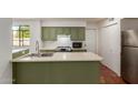 Kitchen featuring stainless steel appliances, plenty of cabinet space, white backsplash, and a double sink at 3030 W Christy Dr, Phoenix, AZ 85029