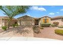 Home with a desert landscape, a mature tree, and a welcoming two car garage at 31318 N 26Th Dr, Phoenix, AZ 85085