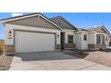 A house with a two-car garage, desert landscaping, and neutral color palette for a welcoming aesthetic at 37785 W Santa Maria St, Maricopa, AZ 85138