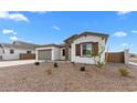 Well-maintained home featuring desert landscaping, a two-car garage, and a charming front facade at 37805 W Santa Maria St, Maricopa, AZ 85138