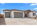 Attractive home with a two-car garage, desert landscaping, and a stylish stone accent entryway at 37805 W Santa Maria St, Maricopa, AZ 85138