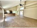 Inviting living room featuring high ceilings, ceiling fan, natural light, and access to the outdoor space at 3877 W Butler St, Chandler, AZ 85226