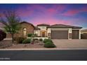 Stunning single-story home with lush landscaping, a stone facade, and a three-car garage at 3912 E Ellis St, Mesa, AZ 85205