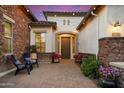 Inviting front entrance with a paver patio, stone accents, and ambient string lights at 3912 E Ellis St, Mesa, AZ 85205