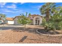 Attractive single-story home with desert landscaping, tile roof and inviting front entrance at 515 W Smoke Tree Rd, Gilbert, AZ 85233