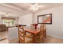 Bright dining area featuring wood table, chairs, and open view to living room at 5808 E Brown Rd # 119, Mesa, AZ 85205