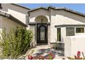 Close-up of the front door with wrought iron detail, set in an arched stone entryway at 6174 E Janice Way, Scottsdale, AZ 85254