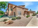 Charming two-story townhome featuring a private balcony and colorful desert landscaping at 6535 E Superstition Springs Blvd # 146, Mesa, AZ 85206