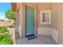 Attractive entryway featuring a teal-colored front door and desert-style landscaping at 6535 E Superstition Springs Blvd # 146, Mesa, AZ 85206