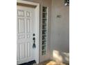 Condo entrance with a white door, glass block sidelight, and unit number 1012 at 7609 E Indian Bend Rd # 1012, Scottsdale, AZ 85250