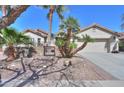 Inviting single-Gathering home featuring a two-car garage and a gated courtyard with mature palm trees at 80 S Laura Ln, Casa Grande, AZ 85194